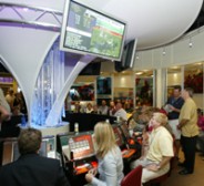 Players are seen enjoying MEC's Horse Wizard machines.